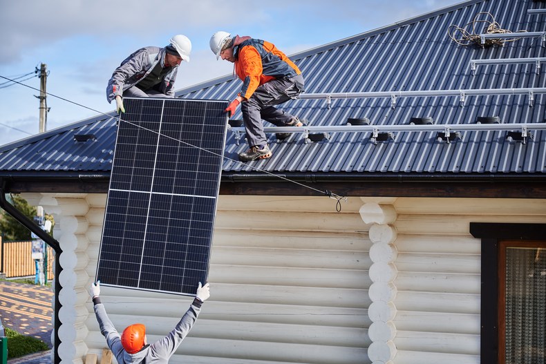 Solar and battery installation crew on an Australian rooftop